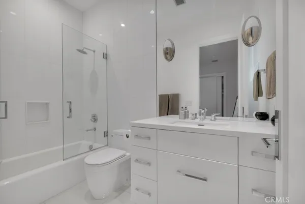 a view of a balcony with chairs and potted plants