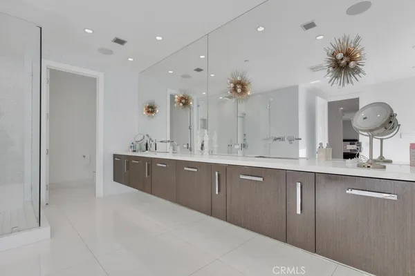 a bathroom with a double vanity sink mirror and toilet
