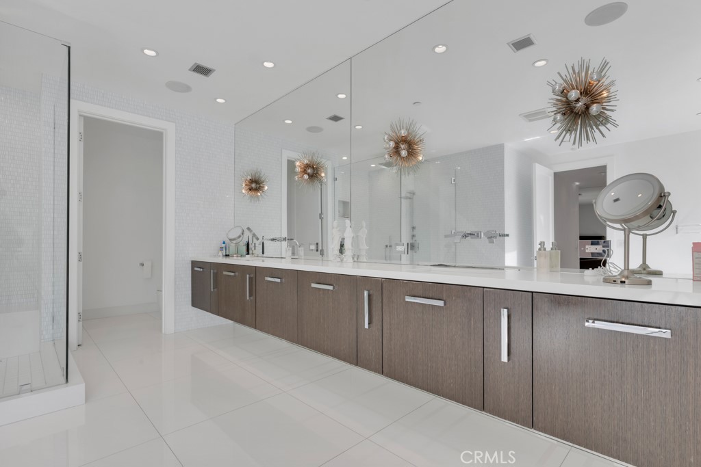 17950 Rancho Street Encino, CA 91316 - Photo 35 of 75 a spacious bathroom with a double vanity sink a mirror and a shower