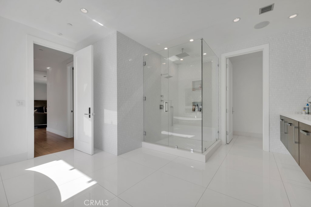 17950 Rancho Street Encino, CA 91316 - Photo 36 of 75 a bathroom with a shower and a glass door
