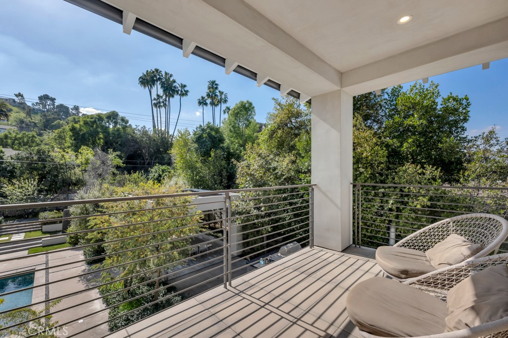 17950 Rancho Street Encino, CA 91316 - Photo 40 of 75 a view of a balcony with chairs and potted plants