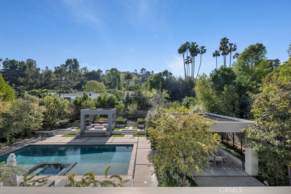 17950 Rancho Street Encino, CA 91316 - Photo 41 of 75 a view of a swimming pool with a yard