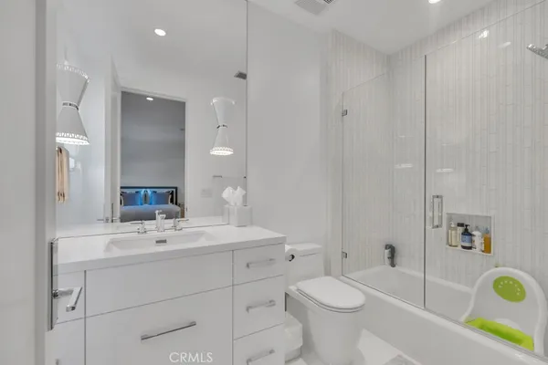 a view of a patio with table and chairs under an umbrella with a small yard