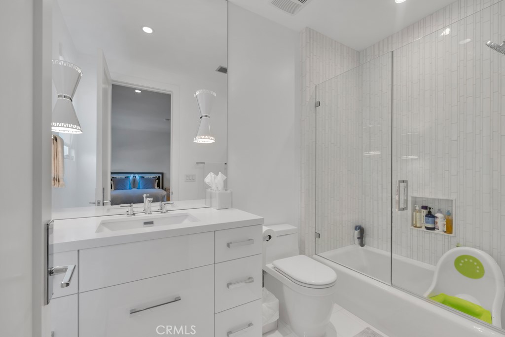 17950 Rancho Street Encino, CA 91316 - Photo 44 of 75 a bathroom with a sink a toilet and shower