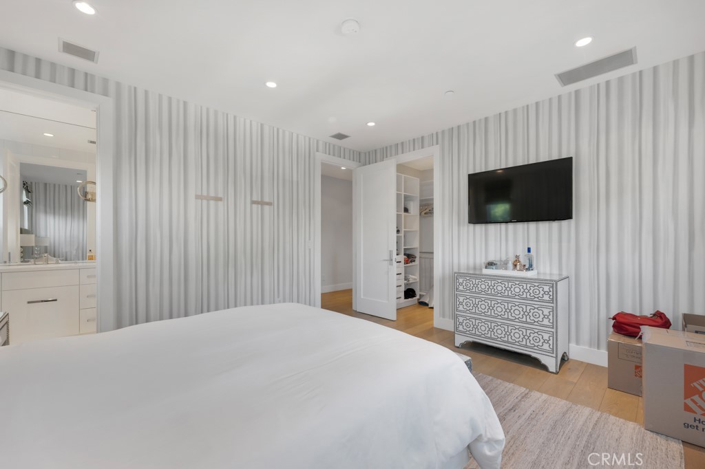 17950 Rancho Street Encino, CA 91316 - Photo 46 of 75 a bedroom with a bed and a flat screen tv