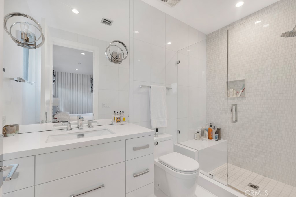 17950 Rancho Street Encino, CA 91316 - Photo 47 of 75 a bathroom with a double vanity sink mirror and toilet