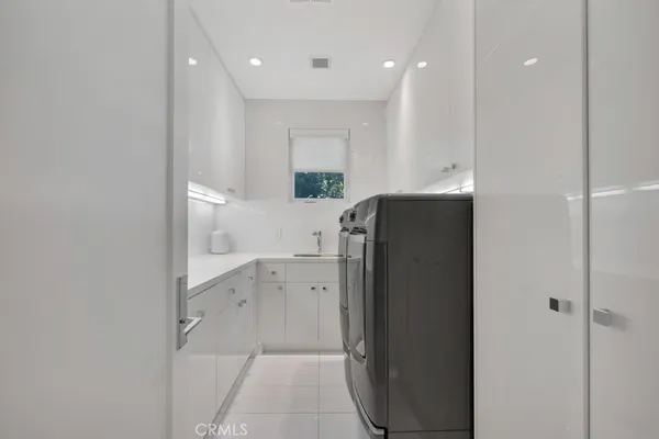 a view of swimming pool with lawn chairs and plants