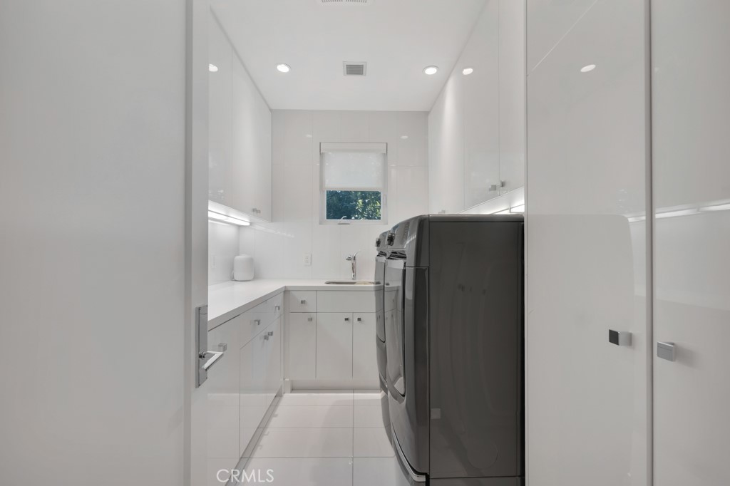 17950 Rancho Street Encino, CA 91316 - Photo 48 of 75 a kitchen with a refrigerator and a sink