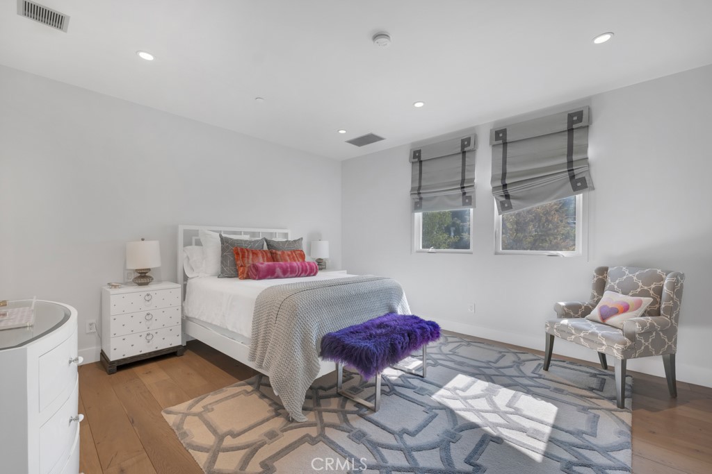 17950 Rancho Street Encino, CA 91316 - Photo 50 of 75 a bedroom with a bed and wooden floor