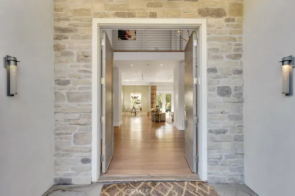 a view of a hallway with a sink and chandelier