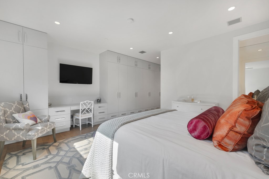 17950 Rancho Street Encino, CA 91316 - Photo 51 of 75 a bedroom with a bed and a flat screen tv