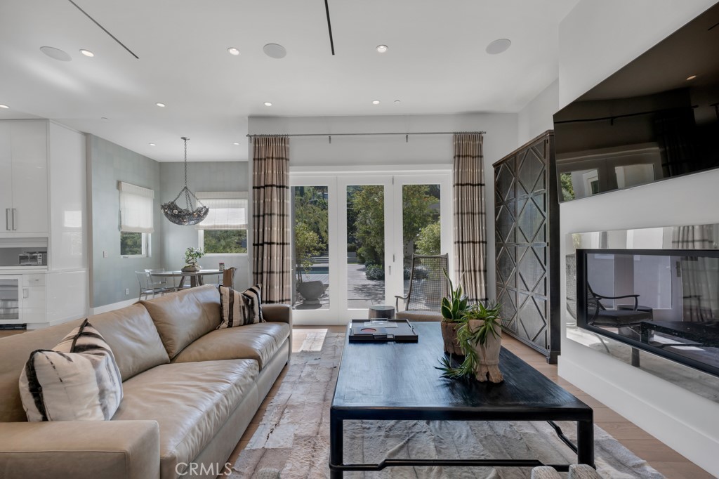 17950 Rancho Street Encino, CA 91316 - Photo 55 of 75 a living room with furniture and a flat screen tv