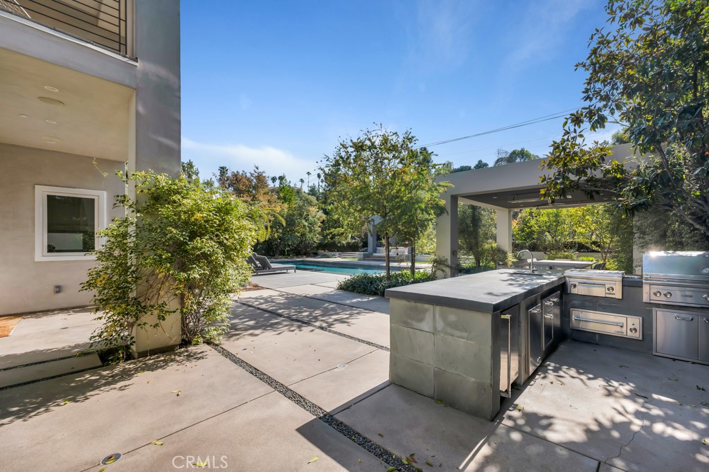17950 Rancho Street Encino, CA 91316 - Photo 56 of 75 a view of a patio with table and chairs and potted plants