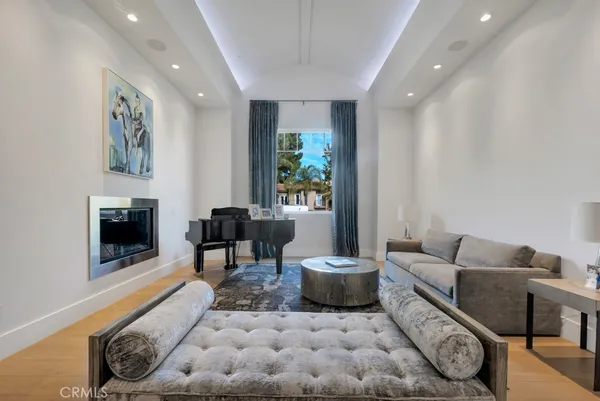 a living room with furniture a fireplace and a flat screen tv