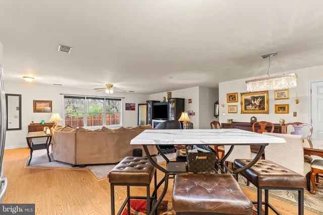 a living room with furniture a dining table and chairs