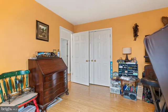 a view of a workspace with furniture and wooden floor