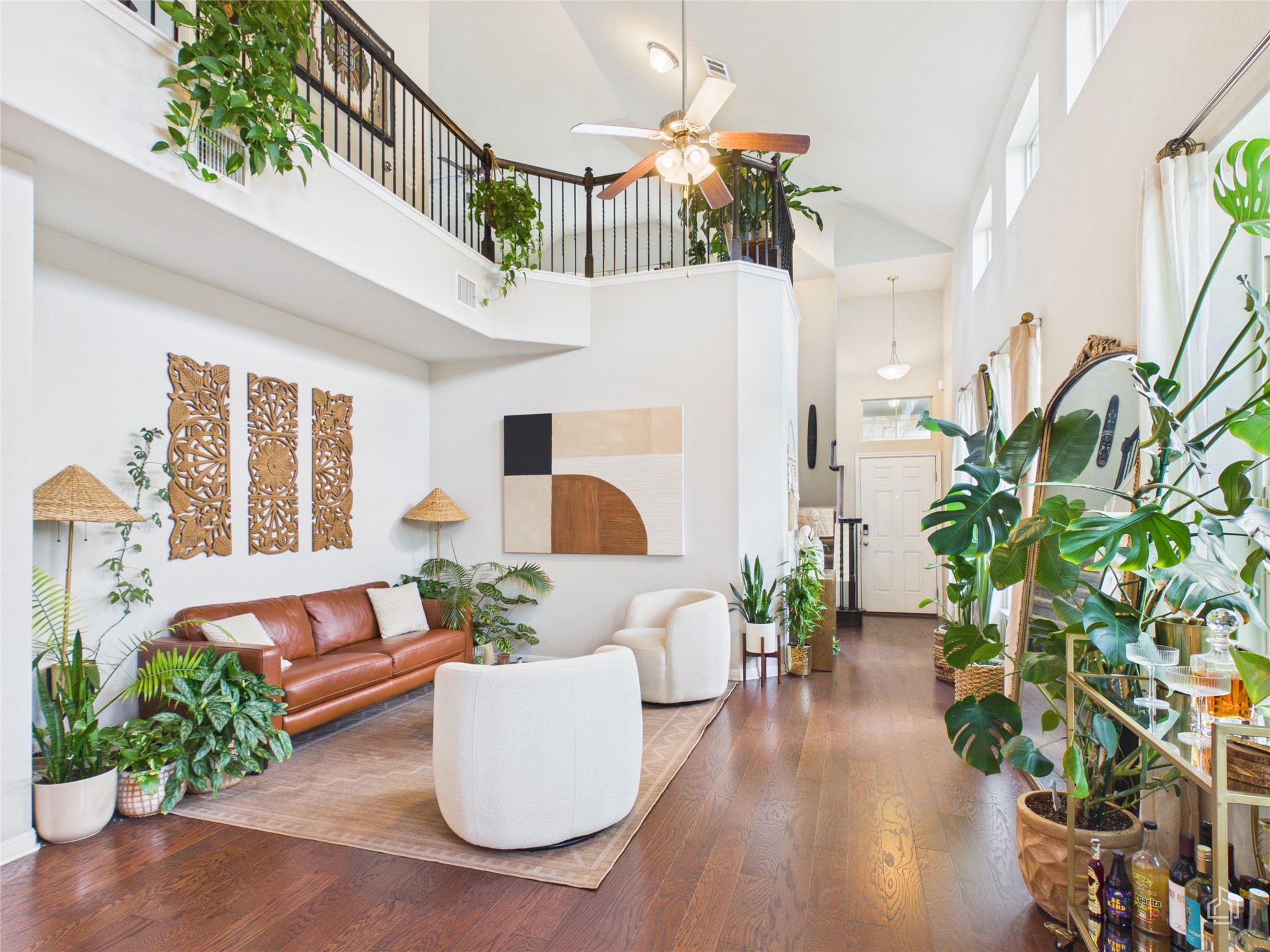 9310 Tanager Way Austin, TX 78748 - Photo 1 of 32 A spacious living area features rich hardwood flooring and a second-story open walkway overlooking the main floor.
