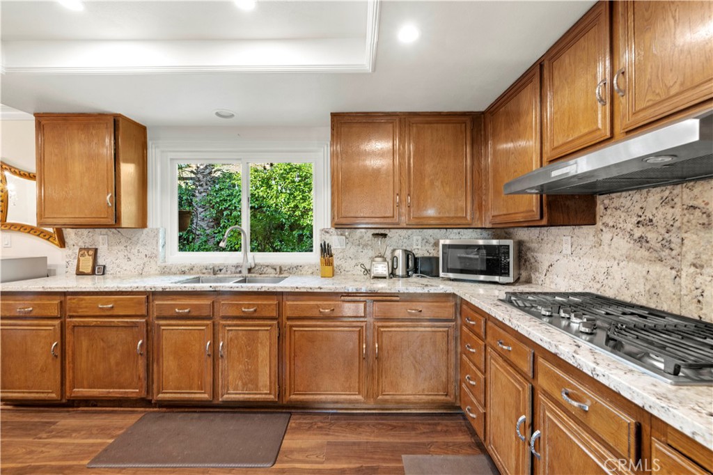 7125 Lonzo Street Tujunga, CA 91042 - Photo 14 of 66 a kitchen with a sink stove and cabinets