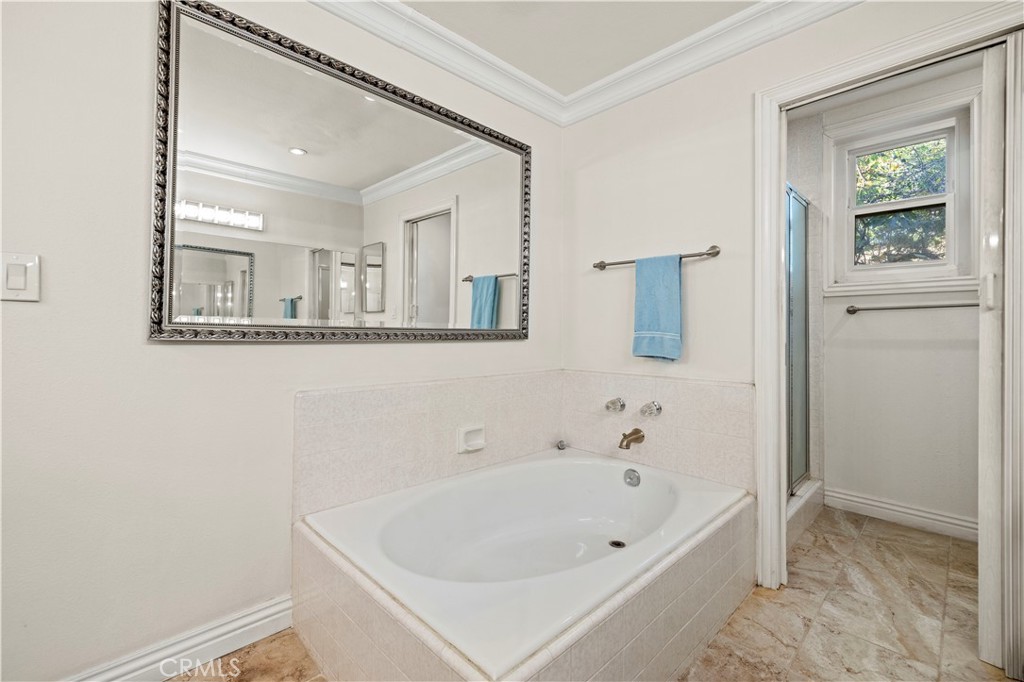 7125 Lonzo Street Tujunga, CA 91042 - Photo 39 of 66 a bathroom with a white bath tub and a shower