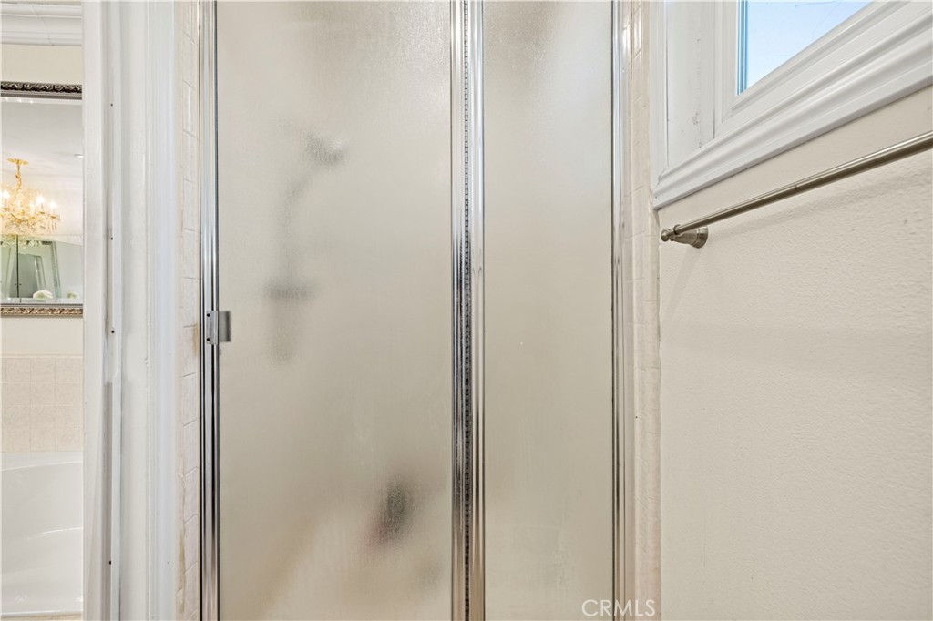 7125 Lonzo Street Tujunga, CA 91042 - Photo 40 of 66 a bathroom with a glass shower door