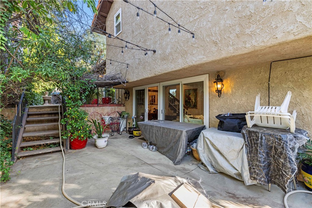 7125 Lonzo Street Tujunga, CA 91042 - Photo 44 of 66 a view of a patio with couches table and chairs and potted plants