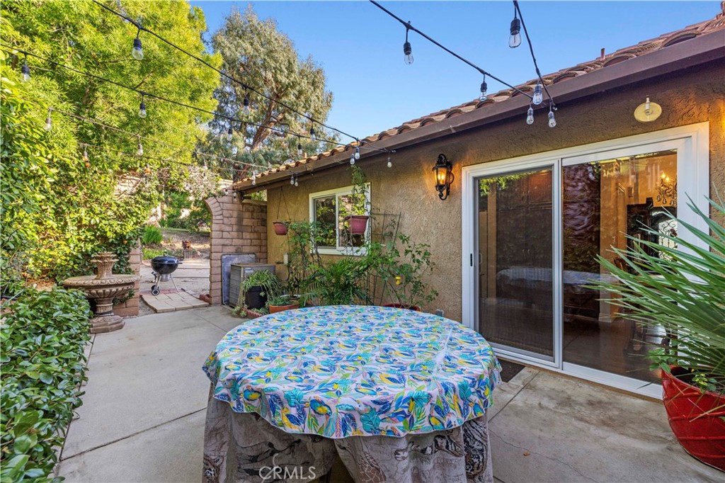 7125 Lonzo Street Tujunga, CA 91042 - Photo 46 of 66 a view of a patio with table and chairs potted plants