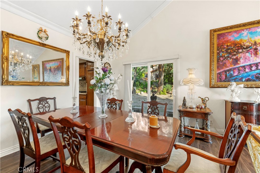 7125 Lonzo Street Tujunga, CA 91042 - Photo 9 of 66 a view of a dining room with furniture a chandelier and wooden floor