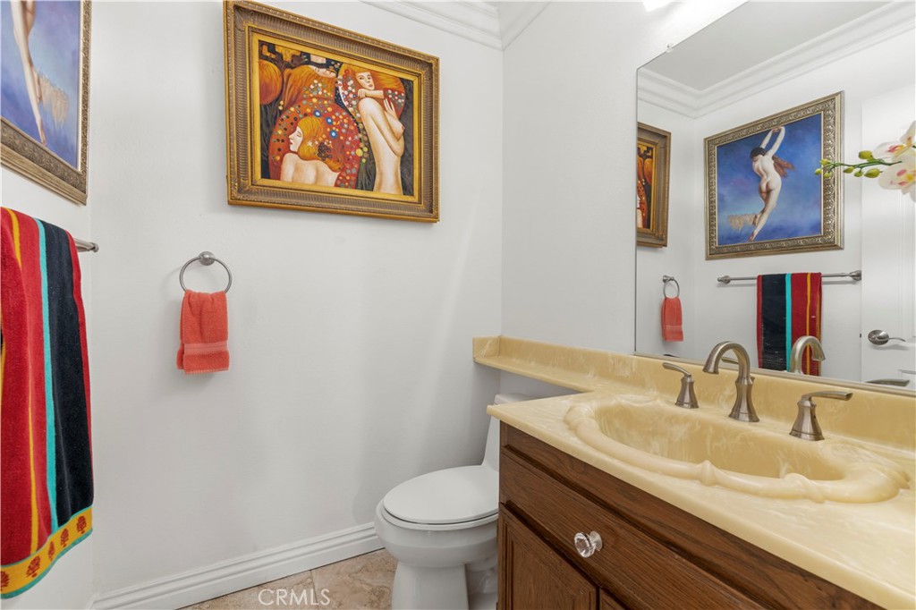 7125 Lonzo Street Tujunga, CA 91042 - Photo 10 of 66 a bathroom with a toilet sink and mirror