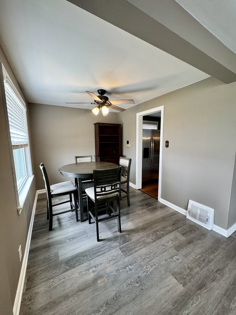 11042 South State Line Road Chicago, IL 60617 - Photo 4 of 12 a living room with furniture and a wooden floor