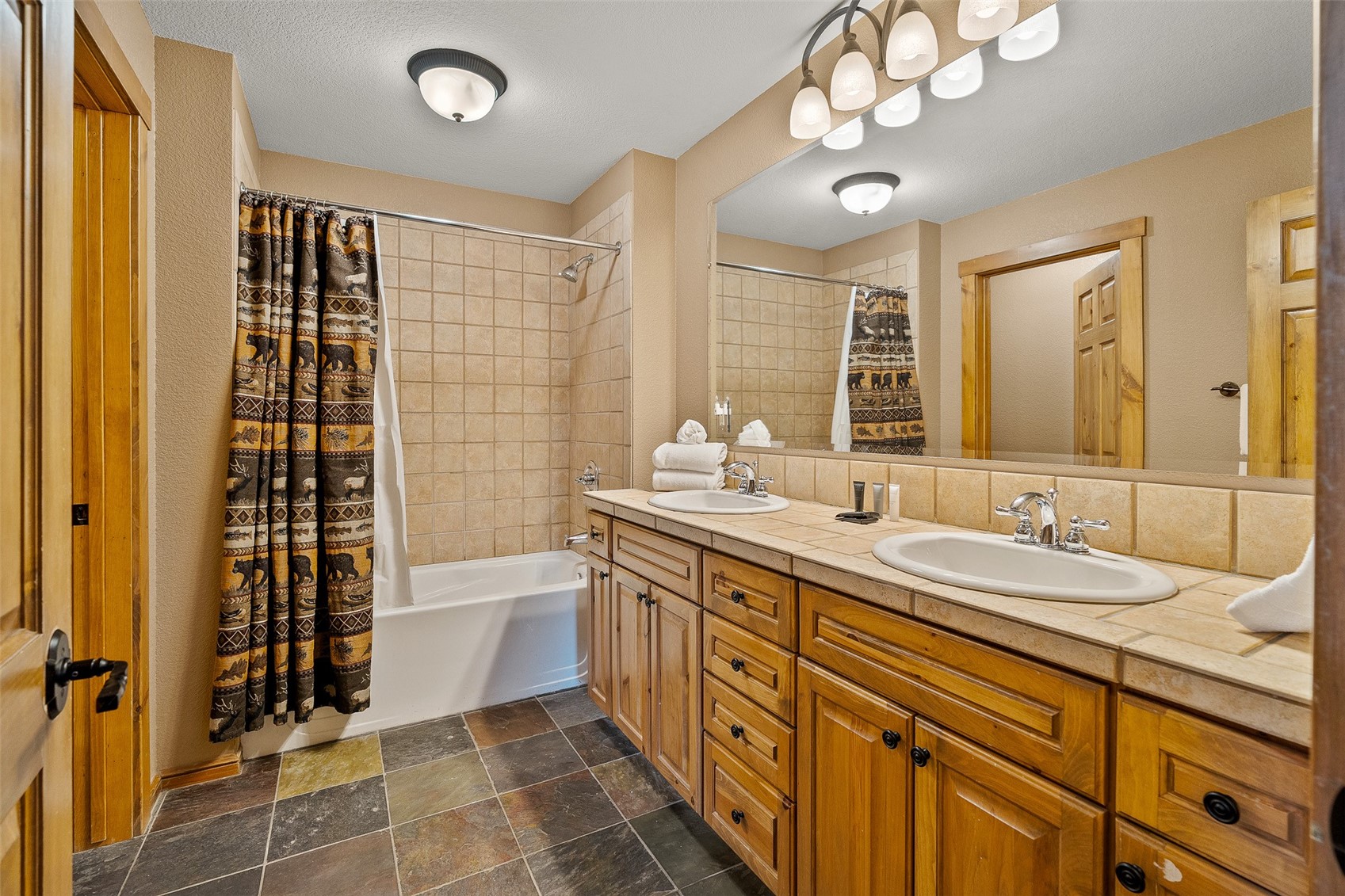 57 Lake Ridge Circle, Unit 1848 Keystone, CO 80435 - Photo 26 of 49 a spacious bathroom with a double vanity sink a large mirror and a bathtub