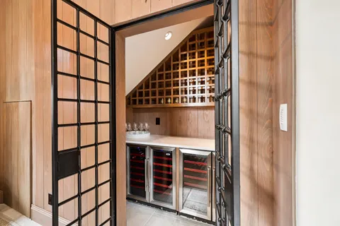 a kitchen that has a kitchen island a stove a table and chairs in it