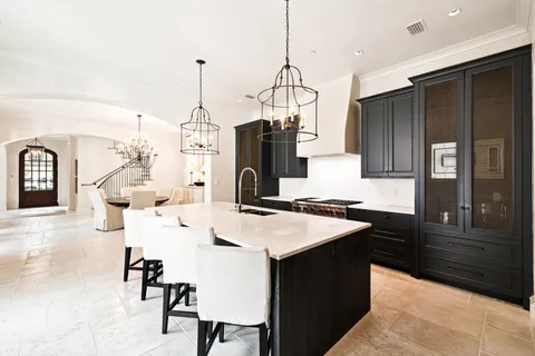 a spacious bedroom with a bed and a chandelier