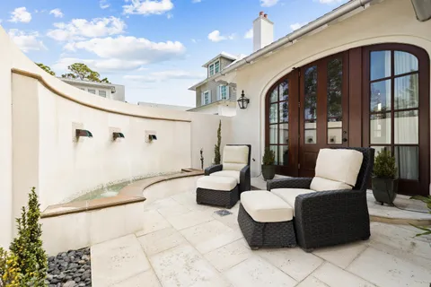 a balcony view with two chairs and a table