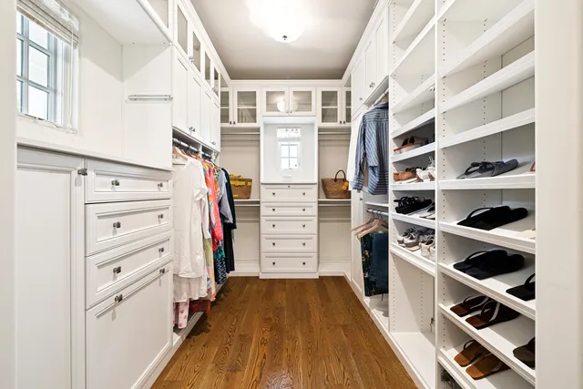 a living room with furniture wooden floor and kitchen view