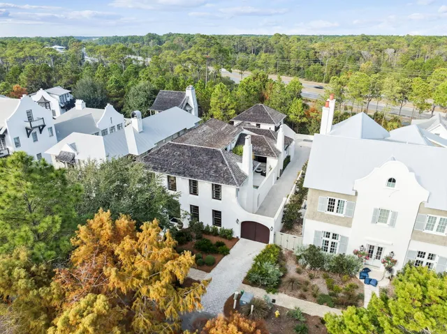a dining room with furniture a fireplace and wooden floor