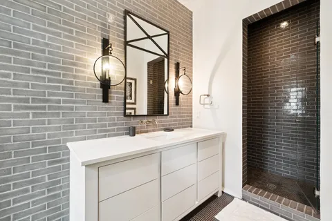 a bathroom with a toilet sink and mirror