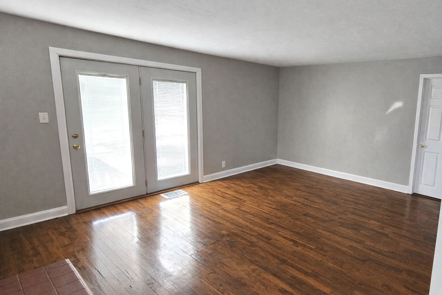 36107 North Green Bay Road Waukegan, IL 60087 - Photo 4 of 17 a view of an empty room with wooden floor and a window