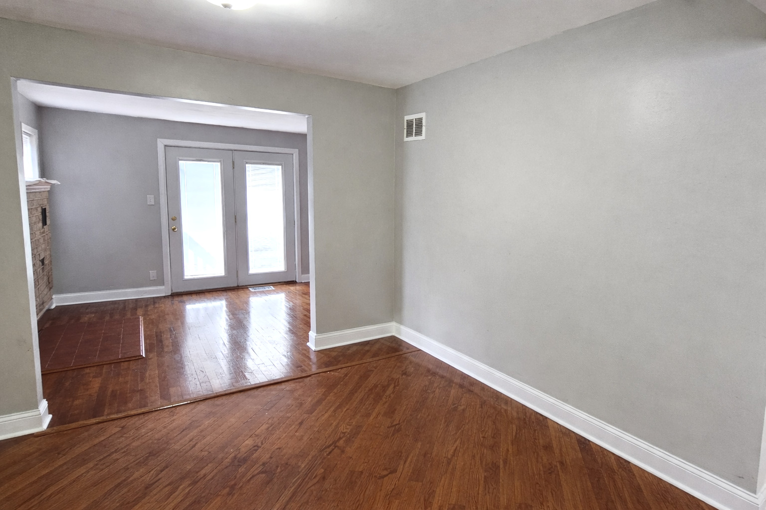 36107 North Green Bay Road Waukegan, IL 60087 - Photo 6 of 17 a view of an empty room with wooden floor and a window