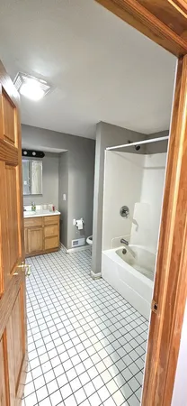 a bedroom with a bed and a shower
