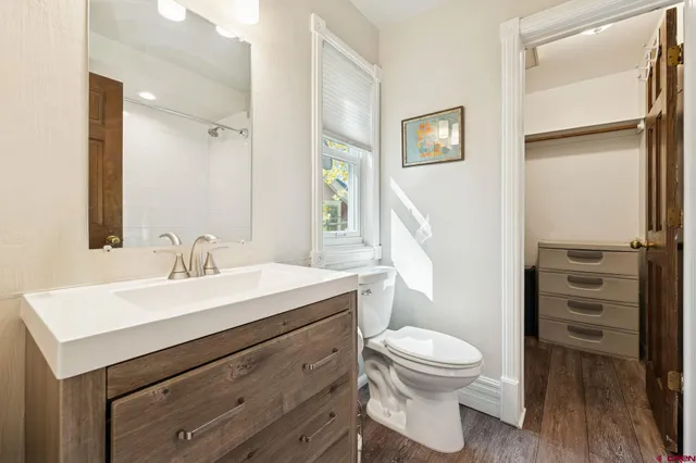 a bathroom with a tub sink and mirror