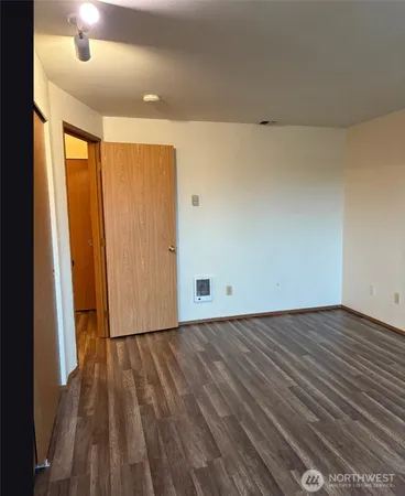 a view of a room with wooden floor