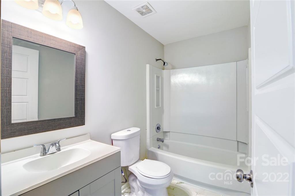 6401 Piney Path Road Charlotte, NC 28212 - Photo 13 of 19 a bathroom with a sink a toilet and shower