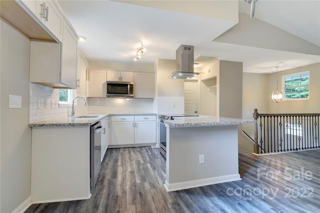 6401 Piney Path Road Charlotte, NC 28212 - Photo 5 of 19 a kitchen with a sink cabinets and wooden floor
