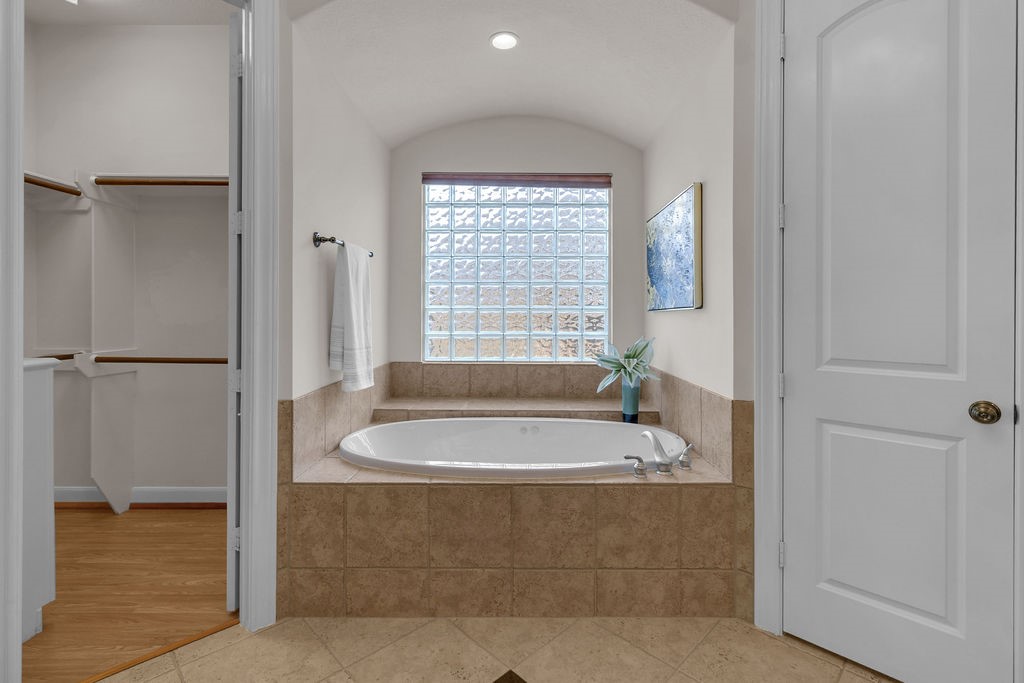 7306 Starflower Katy, TX 77494 - Photo 31 of 50 a bath tub sitting in a bathroom next to a window