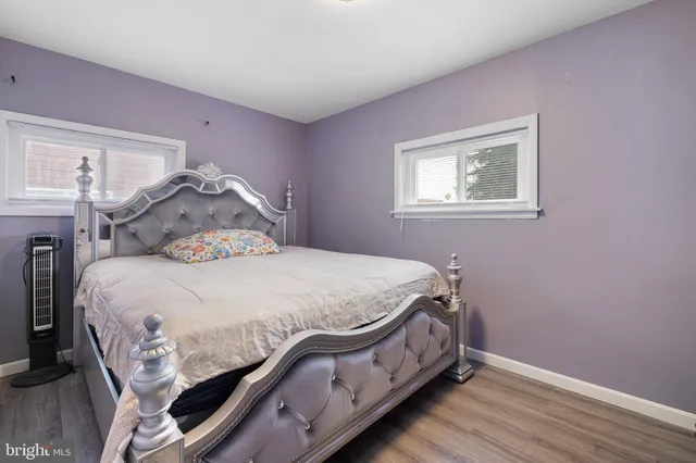 a bed sitting in a bedroom next to a window