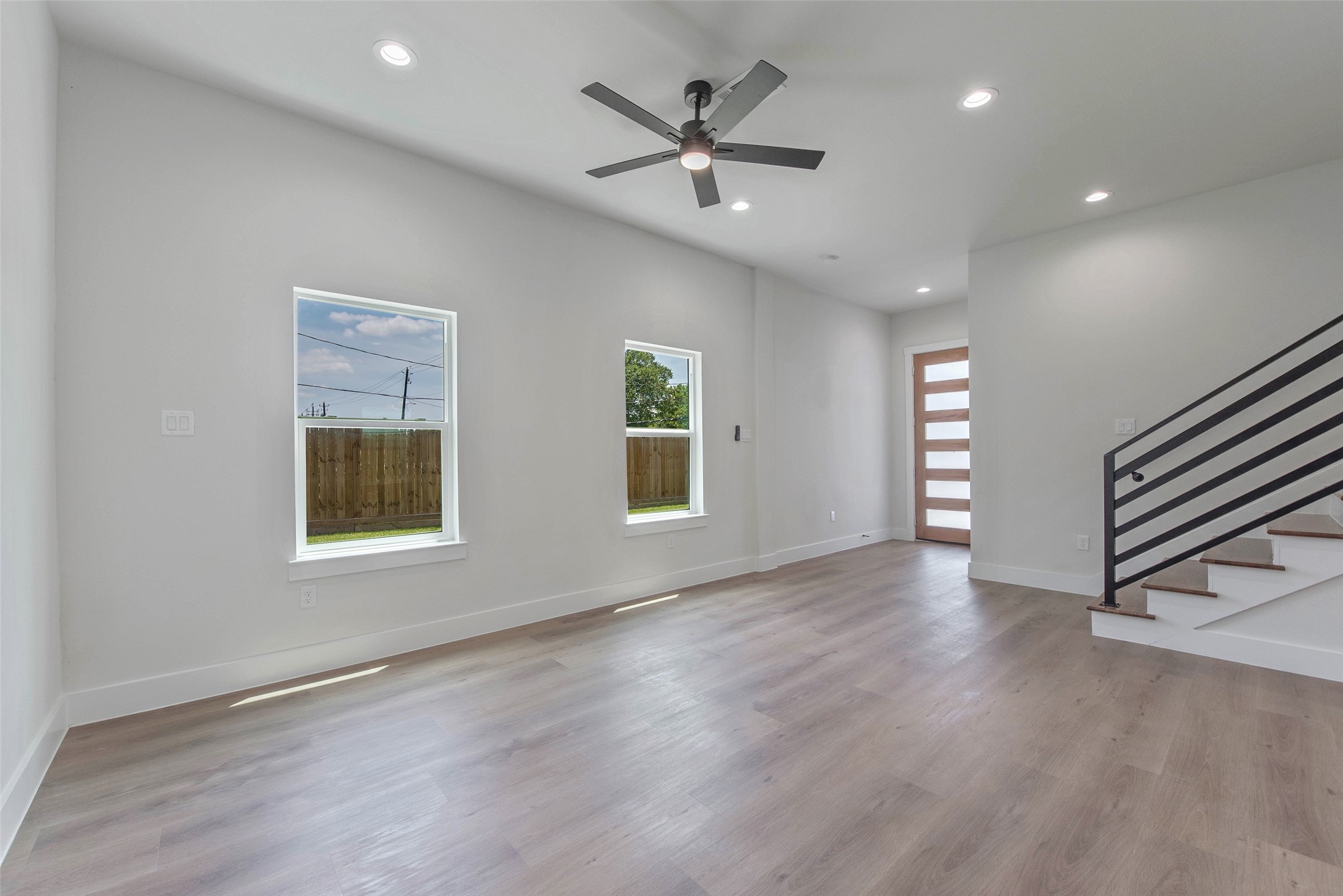 9311 Jutland Road Houston, TX 77033 - Photo 4 of 28 A view from the kitchen captures the seamless flow between the living room and entryway, while the staircase leads upstairs to the bedrooms, baths, and versatile flex space.