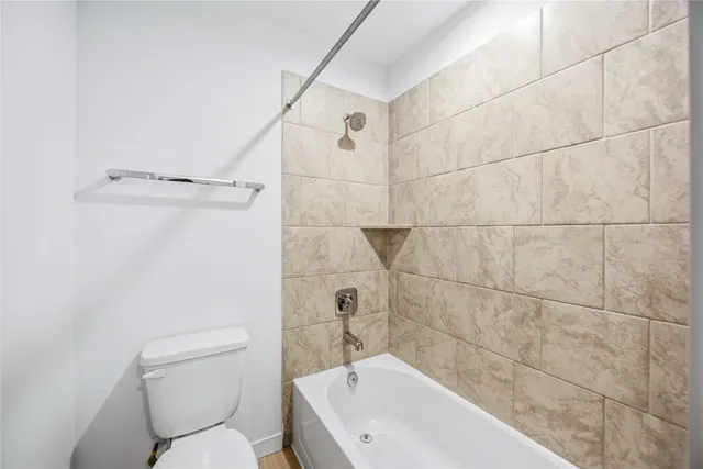 a white bath tub sitting next to a white toilet