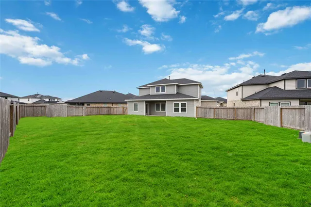 a view of a big house with a big yard
