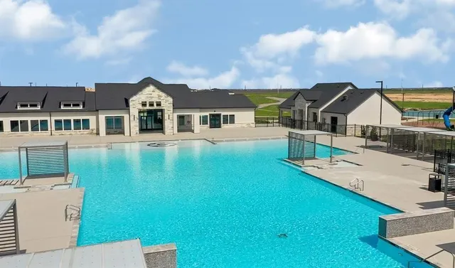 a view of a house with a big yard and large trees