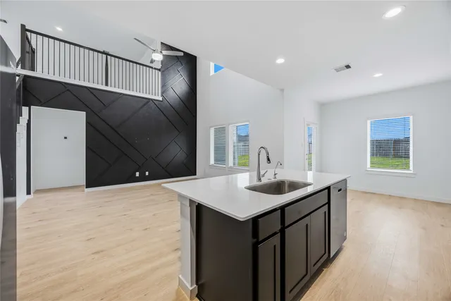 a kitchen with a sink and a mirror